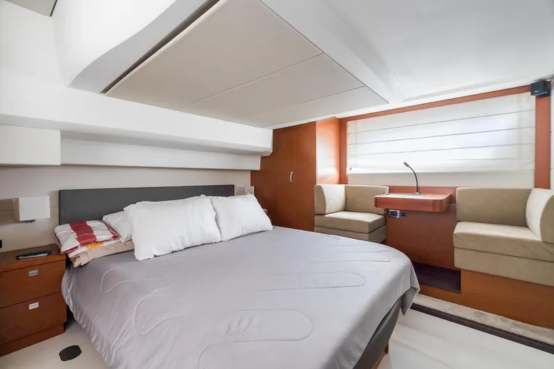 Slide: The Image of Luxurious bedroom interior of 2016 Prestige 500 yacht with modern furnishings and cozy seating area. - 28