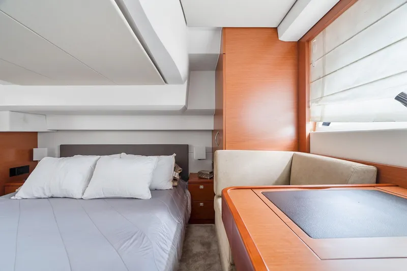 Slide: The Image of Luxurious 2016 Prestige 500 yacht cabin with bed, seating, and window. - 30