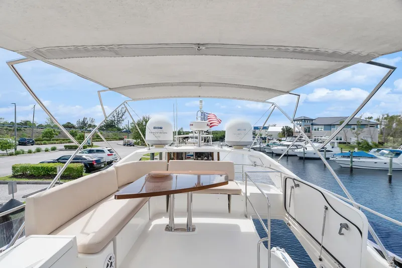 Slide: The Image of Luxurious 2016 Prestige 500 yacht with spacious deck and seating area, docked at marina. - 34