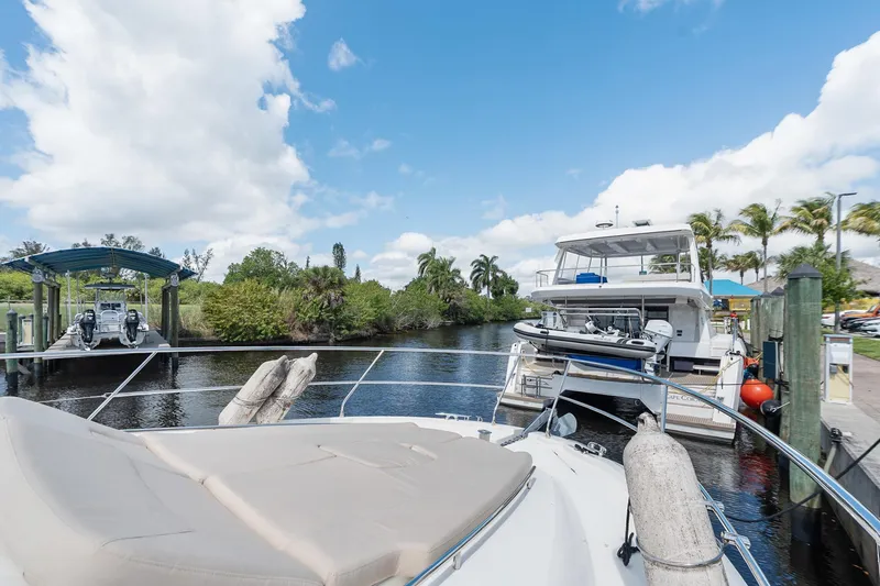 Slide: The Image of Prestige 500 yacht docked at marina, surrounded by lush greenery and clear blue sky. - 35
