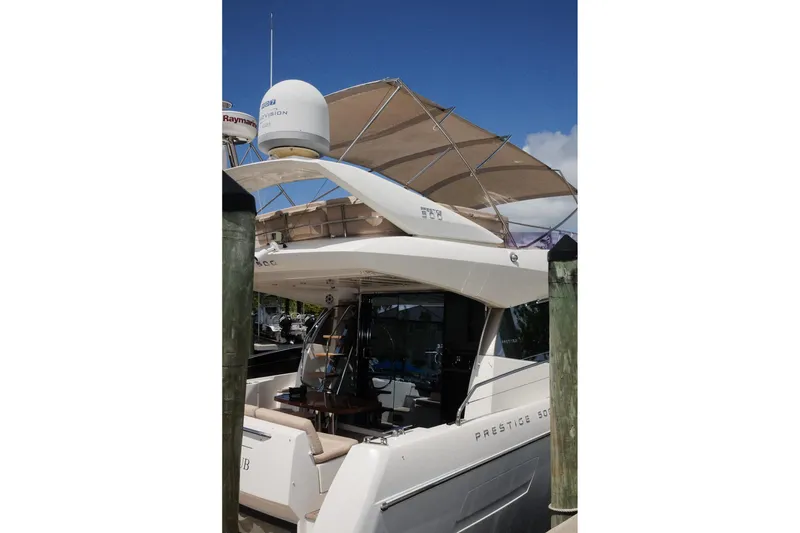 Slide: The Image of 2016 Prestige 500 yacht docked, featuring a sleek design and spacious upper deck. - 37