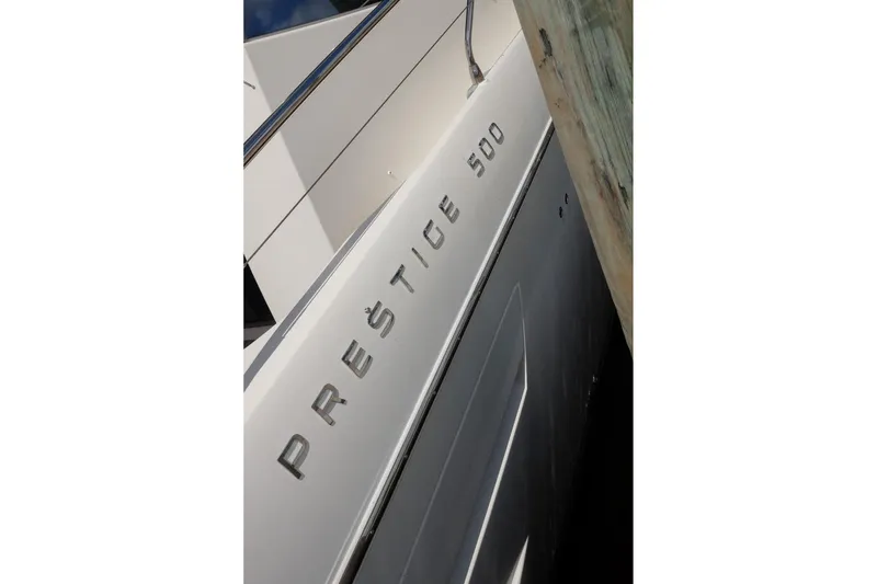 Slide: The Image of 2016 Prestige 500 yacht docked, showcasing sleek design and branding. - 38