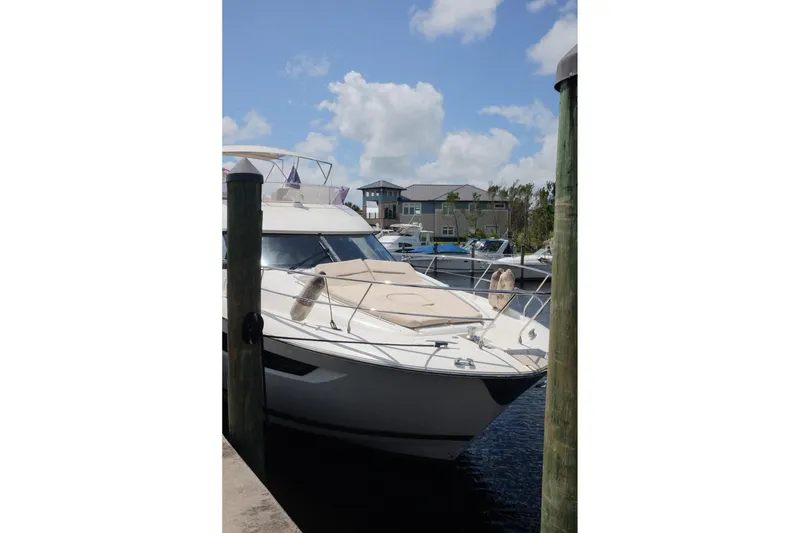 Slide: The Image of 2016 Prestige 500 yacht docked at marina under blue sky. - 39