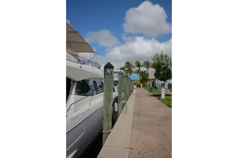 Slide: The Image of 2016 Prestige 500 yacht docked at a marina under a clear blue sky. - 41