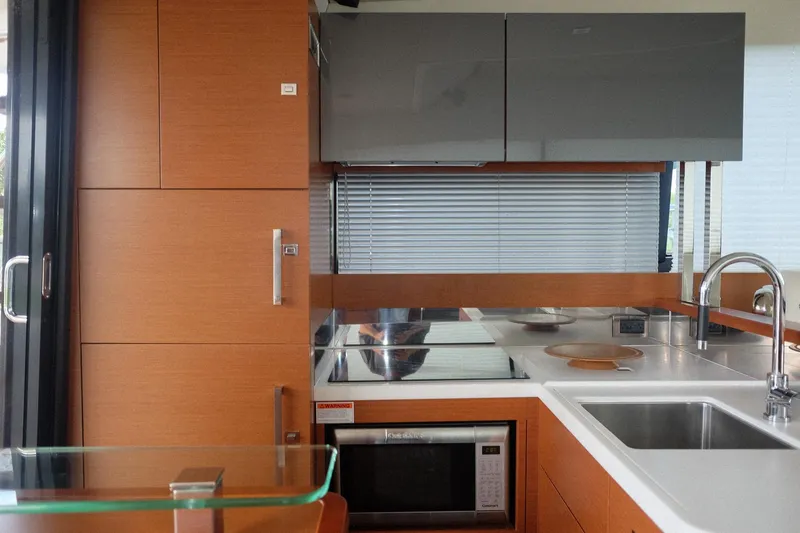 Slide: The Image of Modern kitchen interior on a 2016 Prestige 500 yacht, featuring sleek cabinetry and stainless steel appliances. - 44