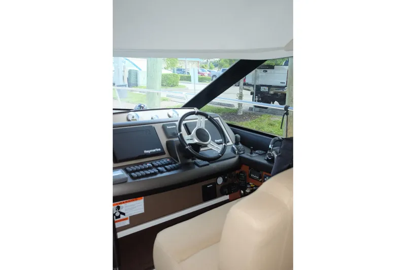 Slide: The Image of Interior helm of 2016 Prestige 500 yacht with steering wheel and navigation controls. - 46