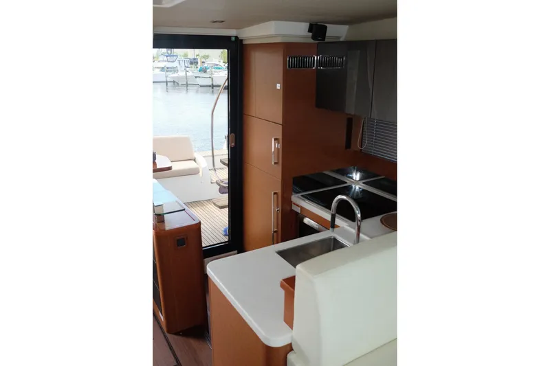 Slide: The Image of Interior of a 2016 Prestige 500 yacht, featuring a modern kitchen and outdoor view. - 47