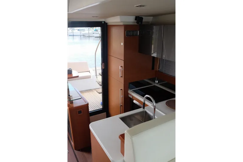 Slide: The Image of Interior of 2016 Prestige 500 yacht, featuring modern kitchen and outdoor seating area. - 48