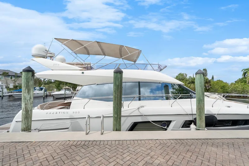 Slide: The Image of 2016 Prestige 500 yacht docked at marina under clear blue sky. - 5