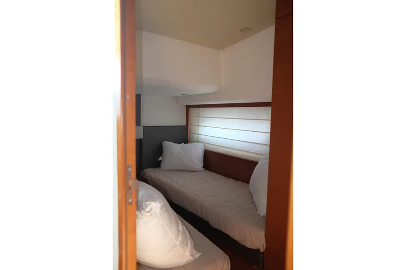 Slide: The Image of Cozy cabin interior of 2016 Prestige 500 yacht with twin beds and soft lighting. - 50