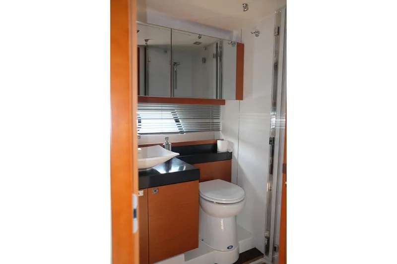 Slide: The Image of Luxurious bathroom in 2016 Prestige 500 yacht with modern fixtures and wood accents. - 51