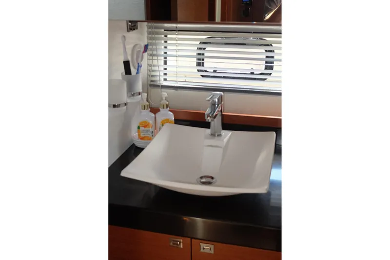 Slide: The Image of Modern bathroom sink on Prestige 500 yacht, 2016 model, with toiletries and window blinds. - 53