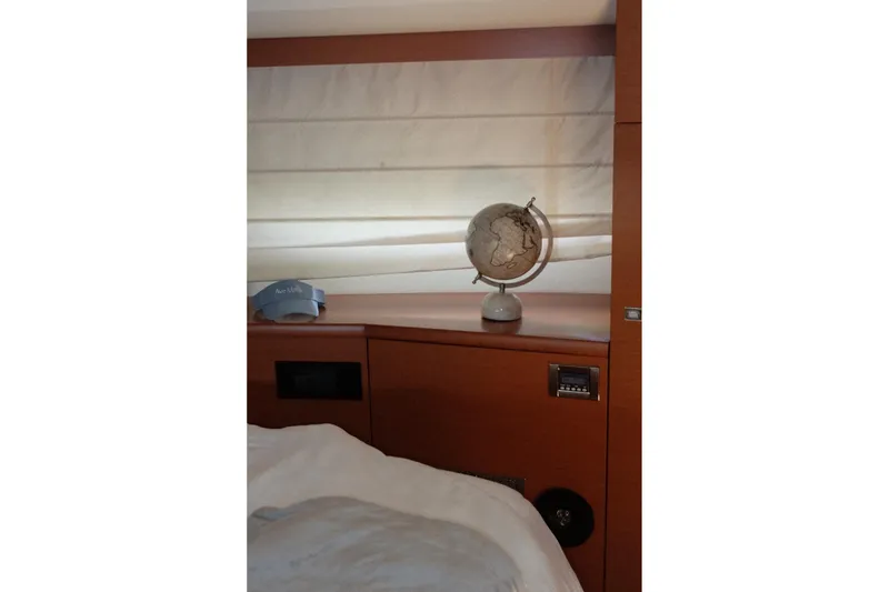 Slide: The Image of Interior of 2016 Prestige 500 yacht with globe and cap on wooden shelf. - 55
