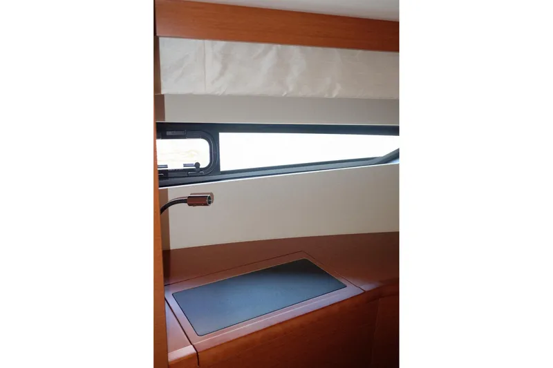 Slide: The Image of Interior view of a 2016 Prestige 500 yacht, featuring a sleek window and wooden finish. - 56
