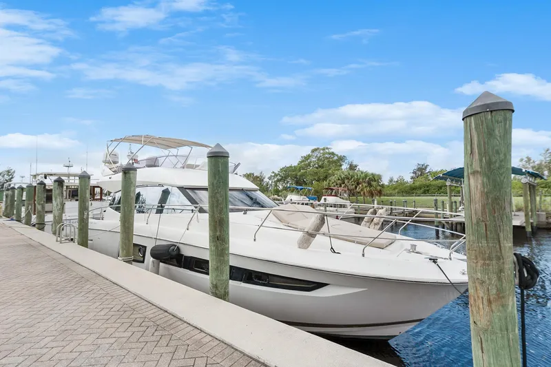 Slide: The Image of 2016 Prestige 500 yacht docked at marina under clear blue sky. - 6