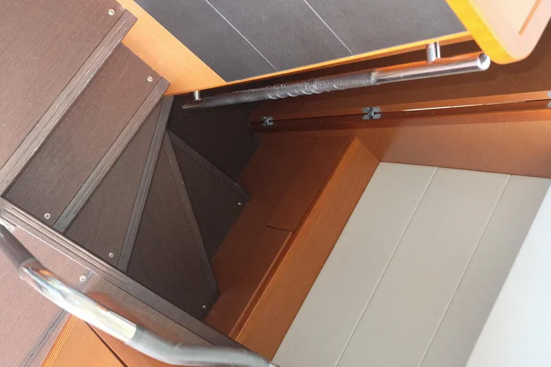 Slide: The Image of Staircase inside 2016 Prestige 500 yacht, featuring sleek wooden design and modern handrails. - 61
