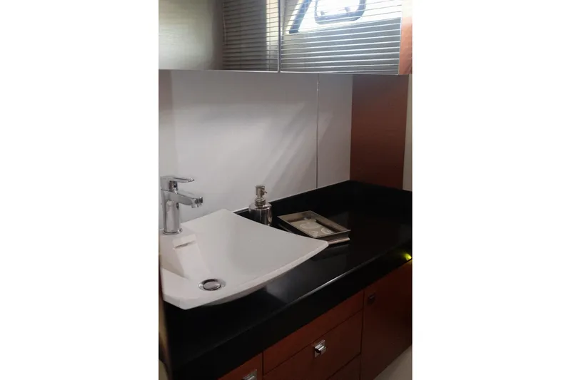 Slide: The Image of Modern bathroom sink in 2016 Prestige 500 yacht, featuring sleek design and chrome fixtures. - 63