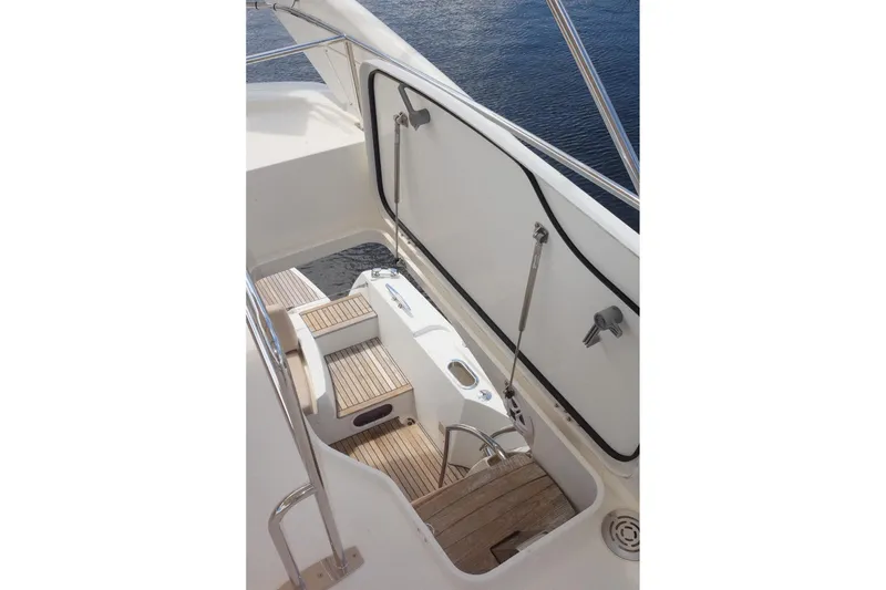 Slide: The Image of 2016 Prestige 500 yacht deck with wooden steps and railing. - 66