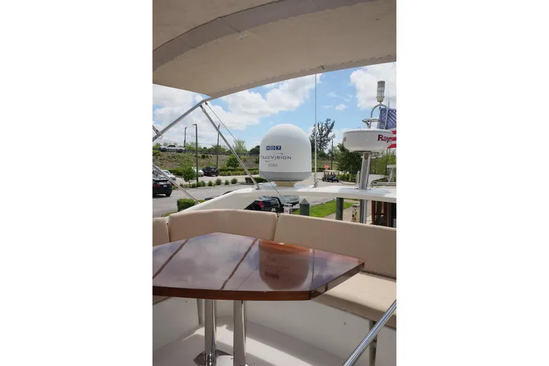 Slide: The Image of 2016 Prestige 500 yacht deck with seating and radar equipment under a sunny sky. - 70