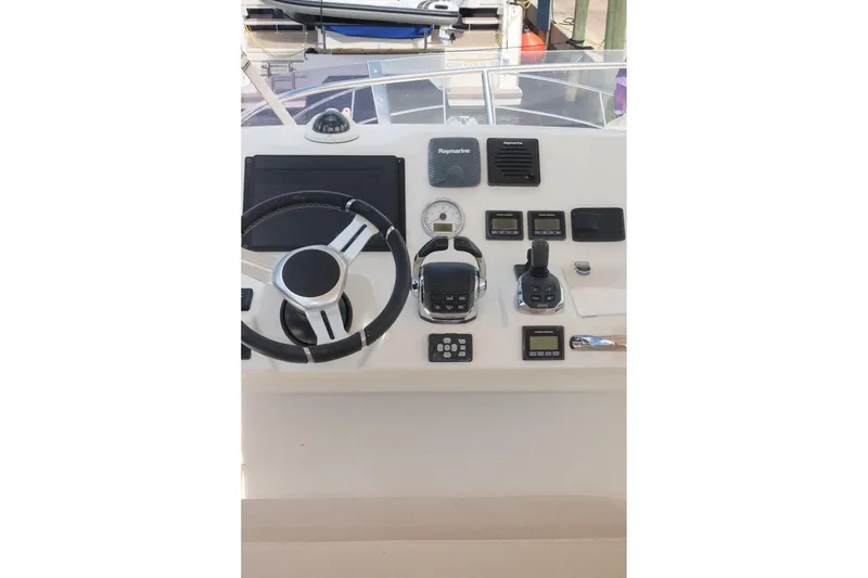Slide: The Image of Control panel of a 2016 Prestige 500 yacht with steering wheel and navigation instruments. - 71
