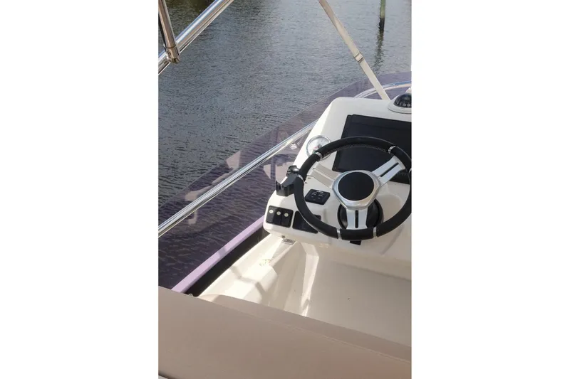 Slide: The Image of Steering wheel of a 2016 Prestige 500 yacht, overlooking calm waters. - 72