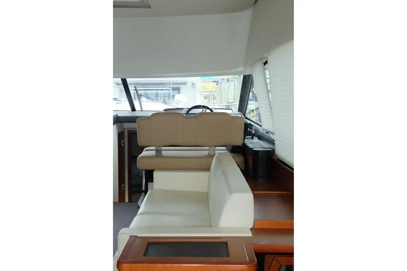 Slide: The Image of Interior of 2016 Prestige 500 yacht with beige seating and modern helm. - 77