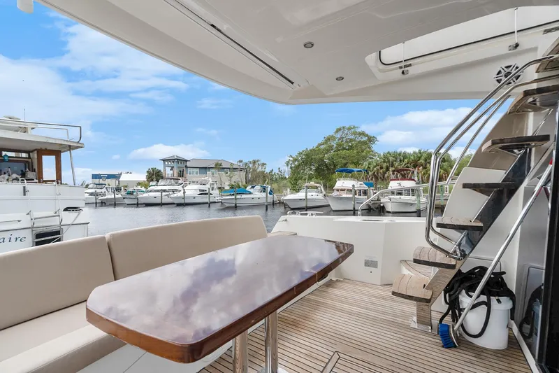Slide: The Image of Luxurious 2016 Prestige 500 yacht interior with marina view, featuring elegant seating and staircase. - 9