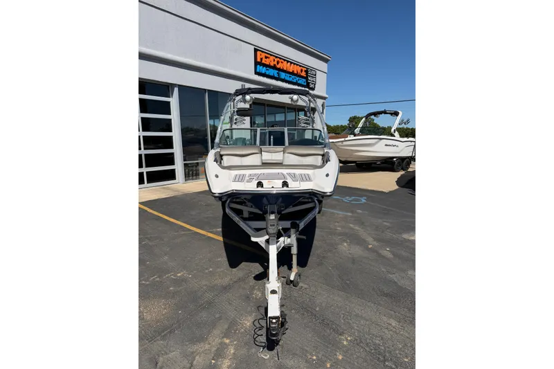 Slide: The Image of 2010 MasterCraft XStar boat on trailer outside dealership, sunny day. - 10