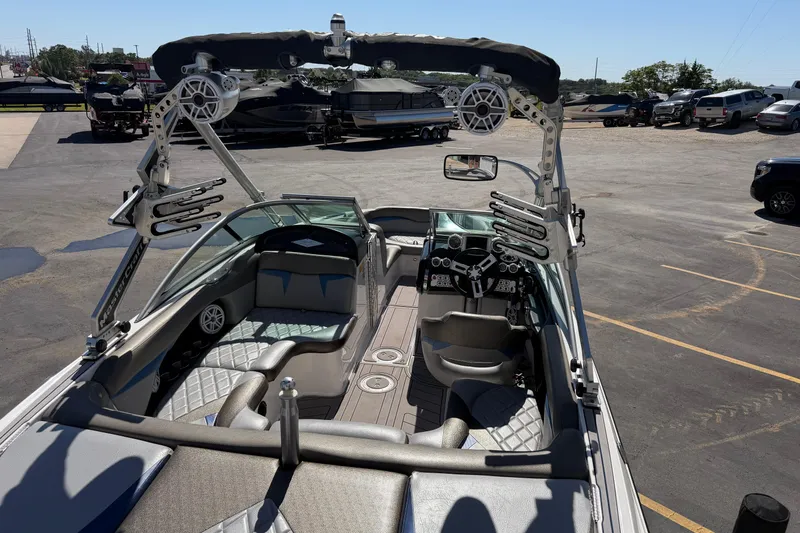 Slide: The Image of 2010 MasterCraft XStar boat interior with sleek seating and advanced dashboard controls. - 12