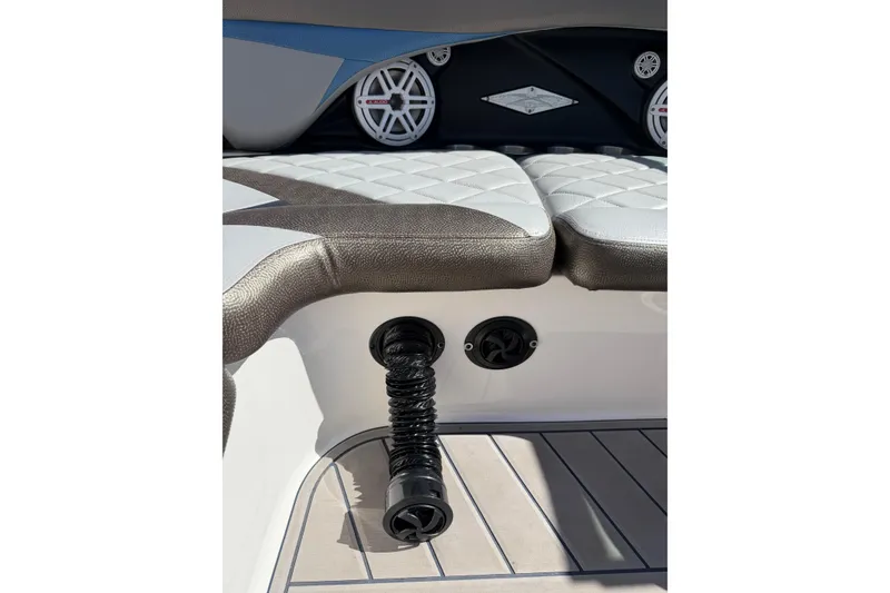 Slide: The Image of 2010 MasterCraft XStar boat interior with cushioned seating and audio speakers. - 16