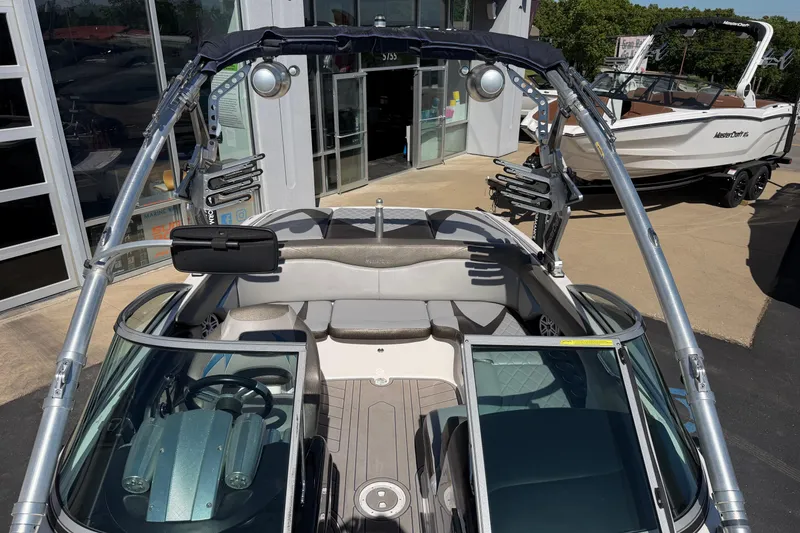 Slide: The Image of 2010 MasterCraft XStar boat with sleek design and modern features, displayed outdoors. - 22