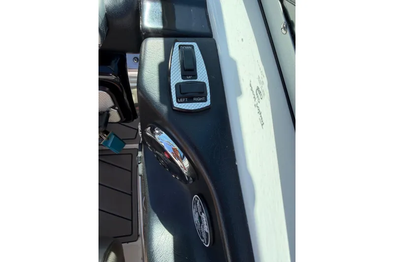 Slide: The Image of 2010 MasterCraft XStar boat control panel with directional switch and logo. - 24