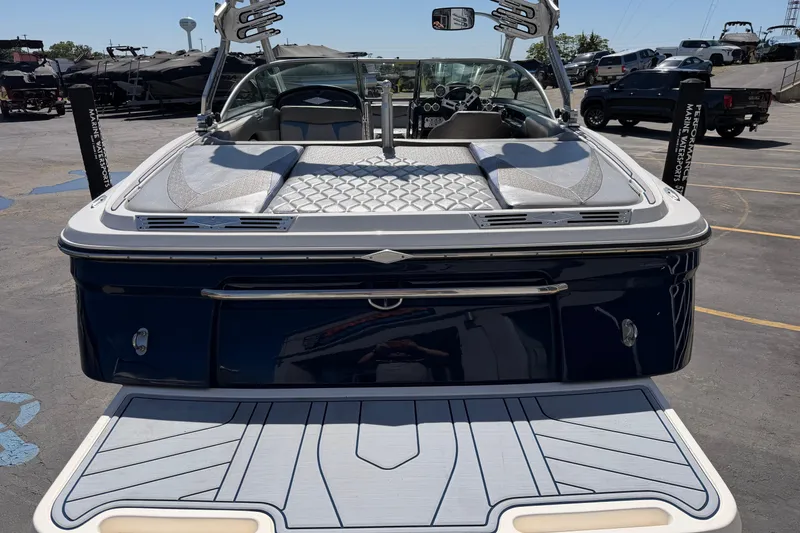 Slide: The Image of 2010 MasterCraft XStar boat, rear view, in a parking lot with other vehicles. - 5