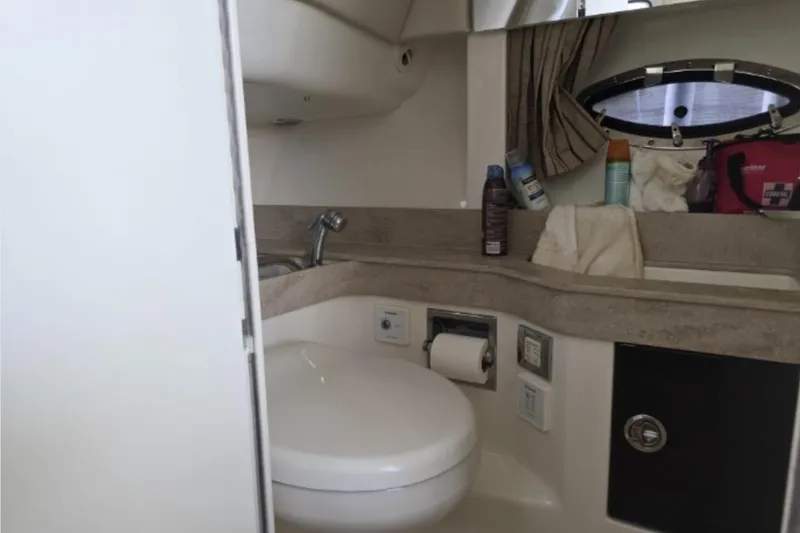 Slide: The Image of 2015 Formula 350 Crossover Bowrider I/O bathroom with sink, toilet, and storage. - 20