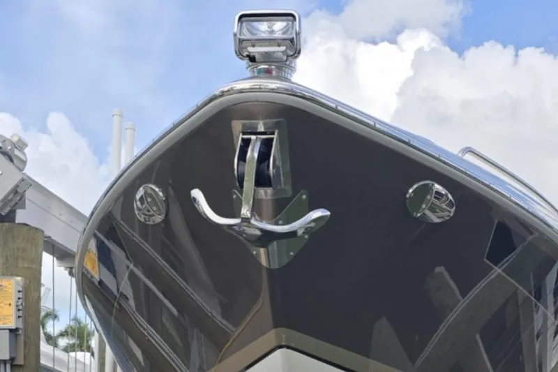 Slide: The Image of 2015 Formula 350 Crossover Bowrider I/O boat bow with anchor, under blue sky. - 11