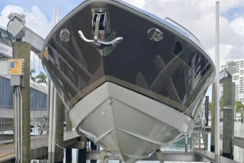 Slide: The Image of 2015 Formula 350 Crossover Bowrider I/O on a lift, dockside view. - 14