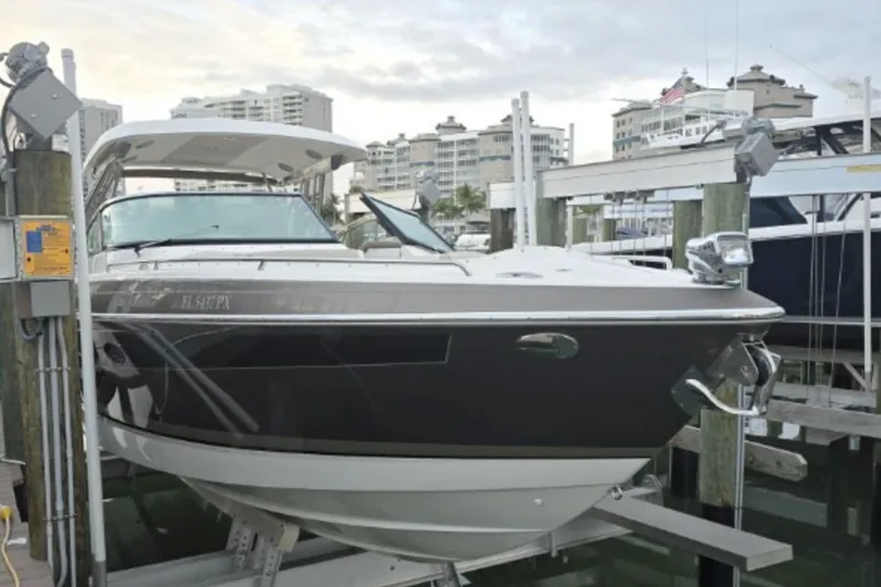 Slide: The Image of 2015 Formula 350 Crossover Bowrider I/O docked at marina with cityscape background. - 5