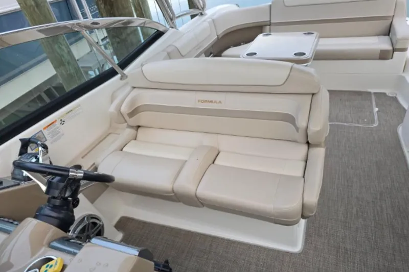 Slide: The Image of 2015 Formula 350 Crossover Bowrider I/O interior with beige seating and steering wheel. - 6