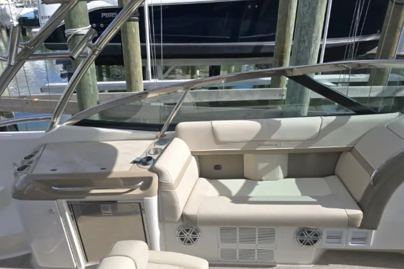 Slide: The Image of 2015 Formula 350 Crossover Bowrider I/O interior with beige seating and sleek design. - 8