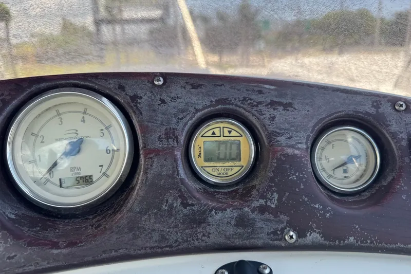 Slide: The Image of Dashboard of a 2007 Bennington 2574 GL boat showing RPM and fuel gauges. - 12