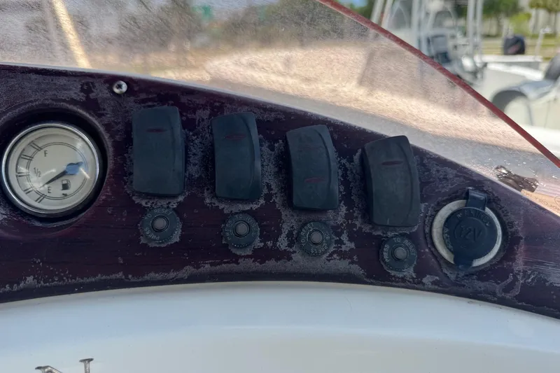 Slide: The Image of Dashboard of a 2007 Bennington 2574 GL boat with switches and fuel gauge. - 13