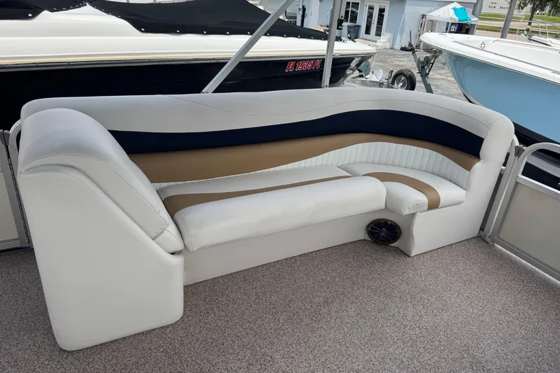 Slide: The Image of 2007 Bennington 2574 GL boat interior with stylish white, navy, and tan seating. - 17