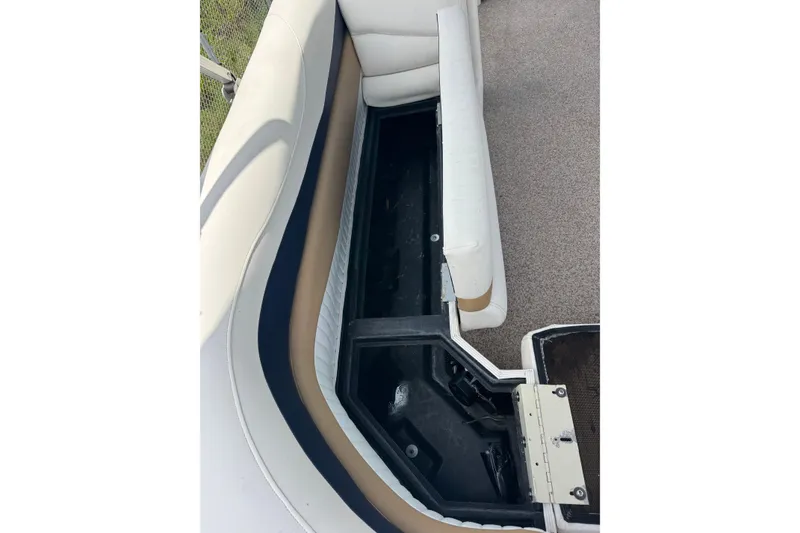 Slide: The Image of Open storage compartment in 2007 Bennington 2574 GL boat with cushioned seating. - 19