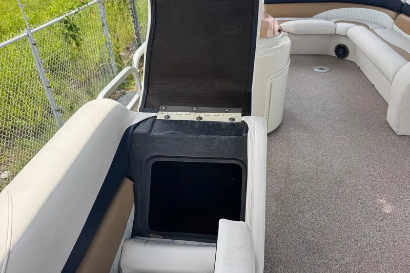 Slide: The Image of Open storage compartment on a 2007 Bennington 2574 GL boat with beige seating. - 20