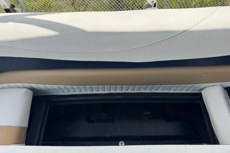 Slide: The Image of 2007 Bennington 2574 GL boat seat storage compartment, open and empty. - 21