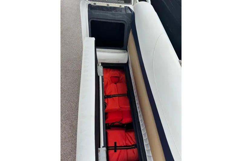 Slide: The Image of Storage compartment with red life jackets on a 2007 Bennington 2574 GL boat. - 23