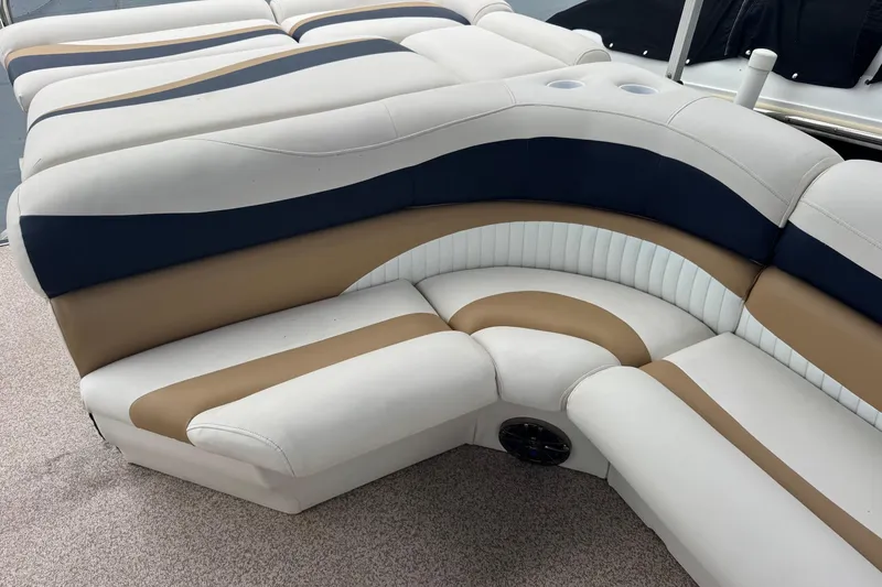 Slide: The Image of Luxurious seating on a 2007 Bennington 2574 GL boat, featuring elegant beige and navy upholstery. - 25
