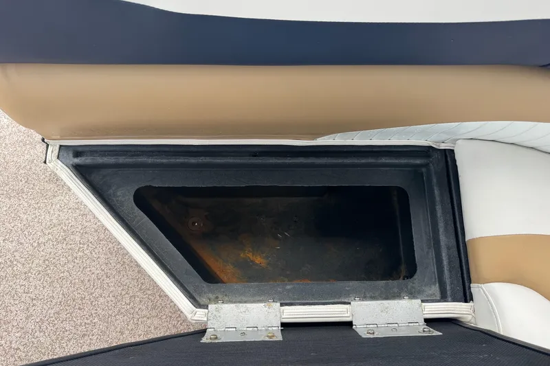 Slide: The Image of Storage compartment in a 2007 Bennington 2574 GL boat, featuring cushioned seating. - 28