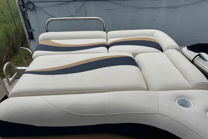 Slide: The Image of 2007 Bennington 2574 GL boat seating with beige, navy, and tan upholstery design. - 29