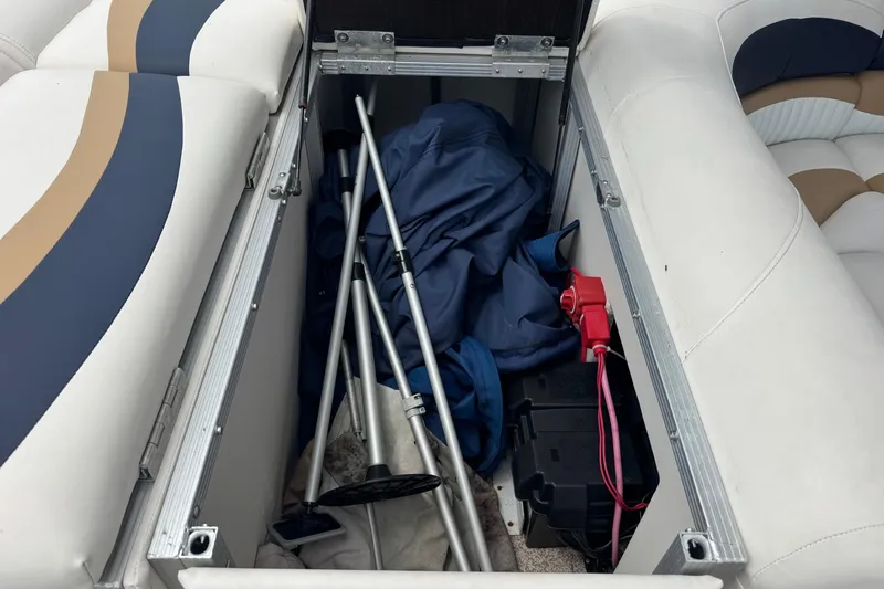 Slide: The Image of Storage compartment of a 2007 Bennington 2574 GL boat with equipment and battery. - 30